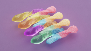 Multiple gummy worms on purple background